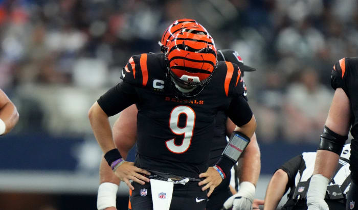 Cincinnati Bengals quarterback Joe Burrow (9) gets up slowly and looks down at this foot after a sack in the third quarter of an NFL Week 2 game against the Dallas Cowboys, Sunday, Sept. 18, 2022, at AT&T Stadium in Arlington, Texas. The Dallas Cowboys won, 20-17. Nfl Cincinnati Bengals At Dallas Cowboys Sept 18 2435